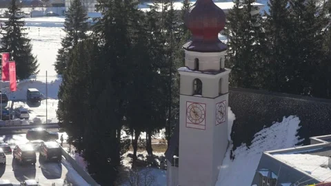 A church clock tower in Davos in the snow Stock Footage 345299379
