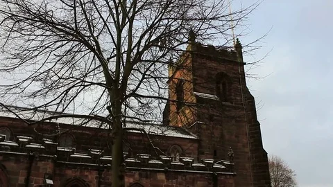 Church clock tower set against blue skies on a snowy morning Stock Footage 83409517