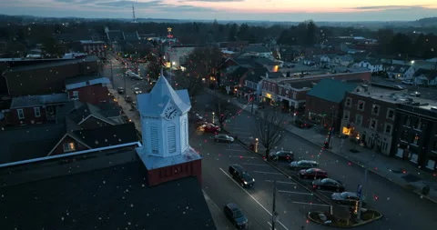 Church clock tower in small town during snowstorm at night. Christmas Stock Footage