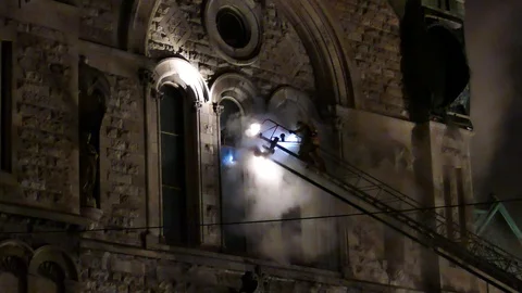 Church on ladder at old structure fire Stock Footage 105353333