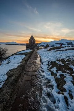 Church on lake sevan at sunset in armenia Stockfoto's