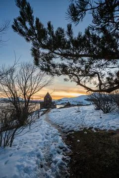 Church on lake sevan at sunset in armenia Stock Photos