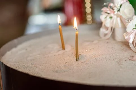 Church lighted candles on the sand Stock Photos