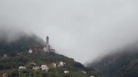 Church on a mountain surrounded by clouds on lake como Video stock 169659900