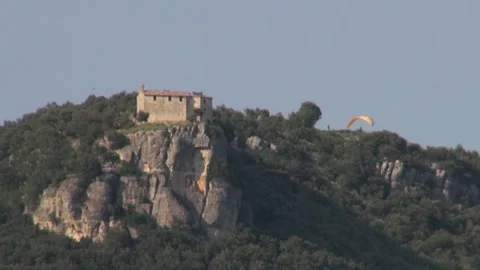Church old elliptical canopy wing paraglider sport mountain trees sky sunlig Stock Footage 346153801