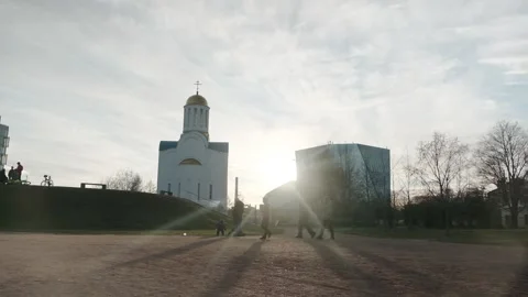 Church in the Rays of the Sun with Passers-by on the background of a Cloudy Sky Stock Footage 135075731