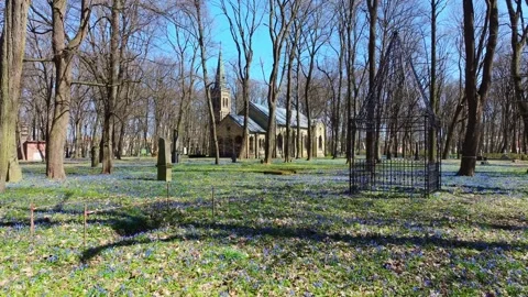 Church Of The Resurrection Stands Among Spring Flowers In Great Cemetery Riga Stock Footage 344007880