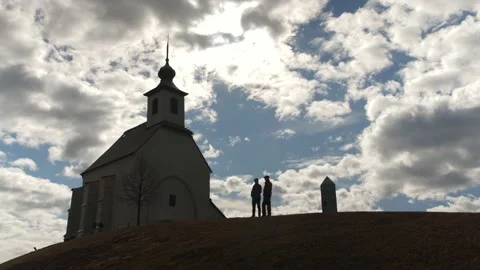 Church in silhouette with two persons Video stock 237760371