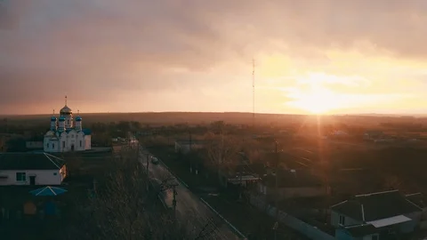 Church in a small town. epic sunset and smooth camera movement - Aerial View Stock Footage 130064375