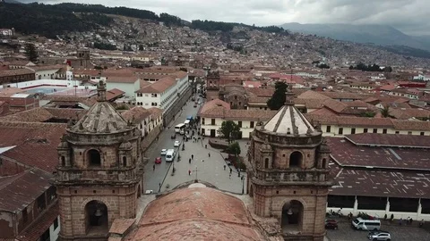 Church Spires Split in Fly By | Sunset Aerial View of Cusco Peru Stock Footage 83579553