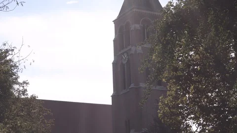 Church steeple in the city with clock Video stock 100121728