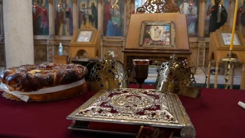 Church table prepared for wedding with bread book crowns candles Vídeo Stock 240904574