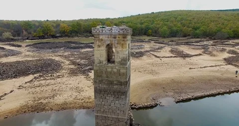 Church tower in an almost dry marsh, La cuerda del pozo, Soria, Vinuesa, Spai Stock Footage 119696328