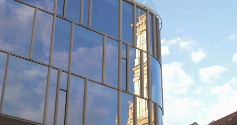 Church tower and clouds in a reflective office window - timelapse video Stock Footage