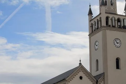 Church tower with clock against cloudy blue sky Stock Photos