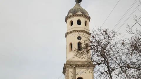 Church tower on cloudy day with stork nest on top Vídeo Stock 240904342