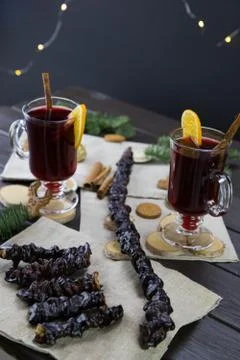 Churchela, mugs of warm wine with an orange, and cookies, ingredients on a wo Stock Photos