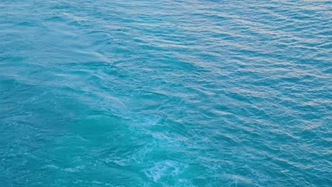 Churning Blue Ocean Water Surface with White Sea Foam ripples Stock Footage 345914216