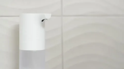 Churning Soap in Dispenser Stock Footage 130407001