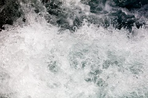 Churning water forms frothy white waves 写真素材