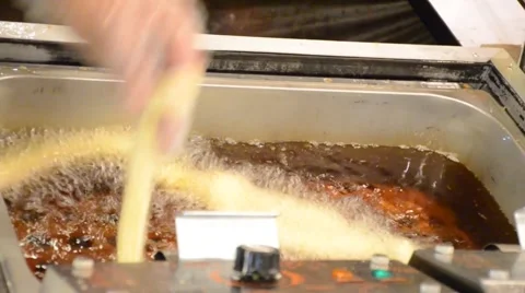Churro deep fried in hot boiled oil HD Stock Footage 61553951