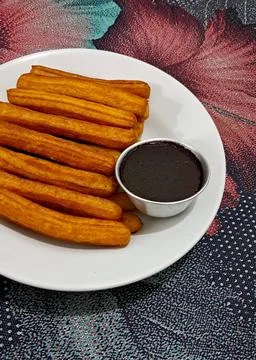 Churros, crispy and golden, dusted with sugar and cinnamon. A delicious, sw.. Stock Photos