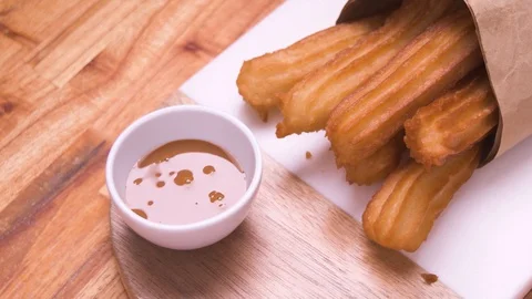 Churros Without Sugar Pan in Paper Bag On Marble and Wood with Dulce de Lech Video stock 128091249
