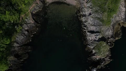 Churston Cove, S. Devon, England: DRONE AERIAL VIEWS: Cove &amp; rugged coastline Stock Footage 241446111