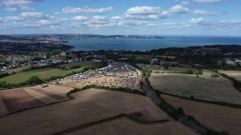 Churston, Devon, England: Drone View: Countryside, sea and Churston Steam Fair Stock Footage 203818581