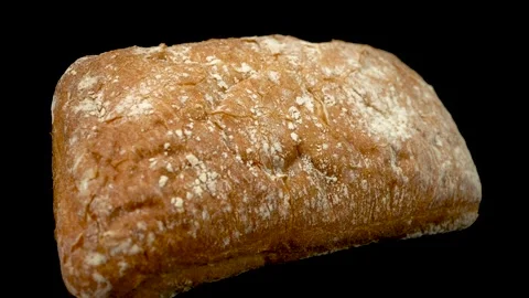 Ciabat bread on a black background close-up. Video stock 148650054