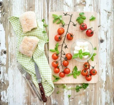 Ciabatta bread with banch of cherry-tomatoes, basil and mozzarella cheese on  Stock Photos