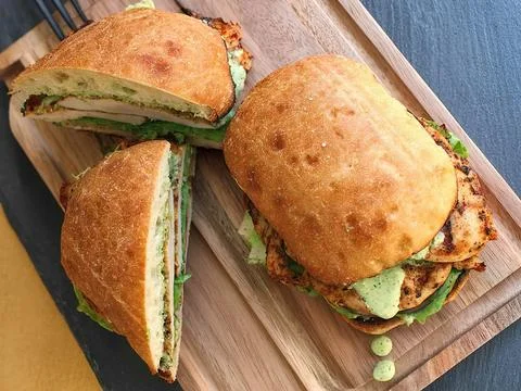 Ciabatta bread filled with chunks of chicken meat Stock Photos