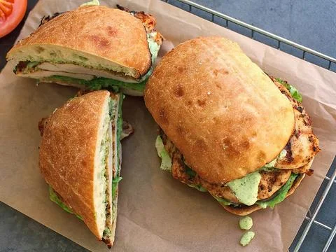 Ciabatta bread filled with chunks of chicken meat Stock Photos
