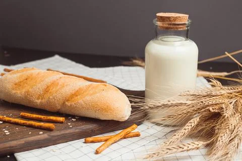 Ciabatta bread with milk bottle and ears of wheat Stock Photos