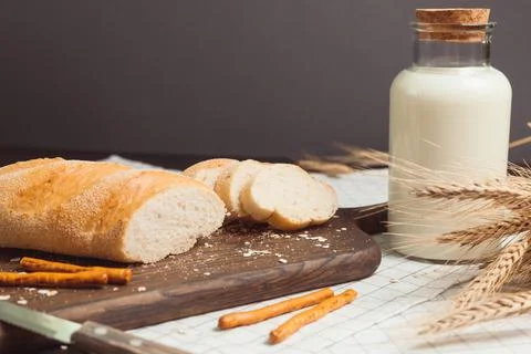 Ciabatta bread with milk bottle and ears of wheat Stock Photos