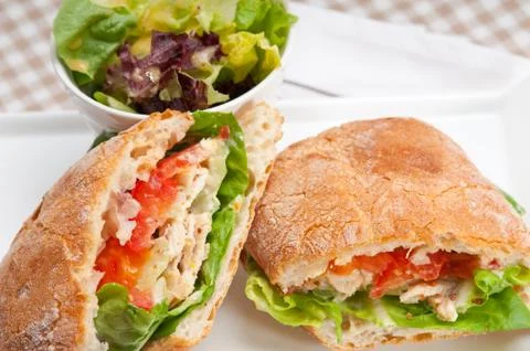 Ciabatta panini sandwich with chicken and tomato Stock Photos