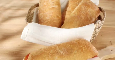 Ciabatta with Prosciutto. Wooden background. Smooth camera movement Stock Footage 243043154