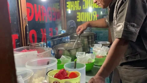 Cianjur, West Java, Indonesia. January 17 2023. A Wedang Jahe seller is pouring  Stock Footage 262419222
