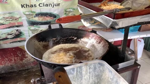 Cianjur, West Java, Indonesia. January 06 2024. the process of frying chicken in Stock Footage 262420172