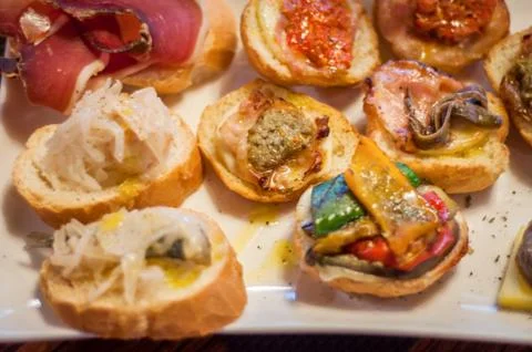 Cicchetti are small snacks served in traditional bars in Venice Stock Photos