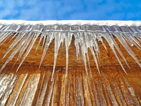 Cicles hanging from the edge Stock Photos