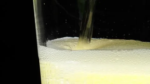 Cider Pours With Apple Slice and Sparkling Bubbles, Macro on Black Background Video stock 305462163