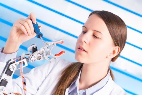 Cientist adjusts the robot arm Stock Photos