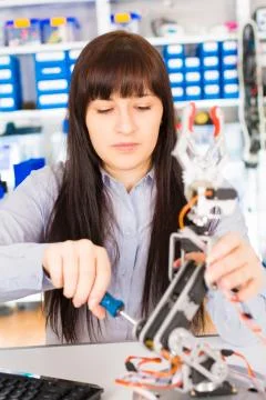 Cientist adjusts the robot arm Foto stock