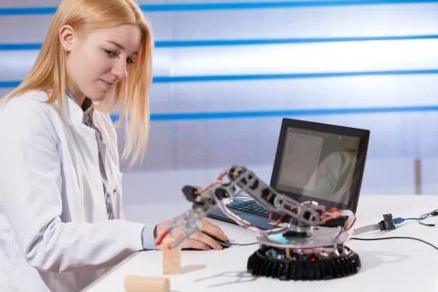 Cientist develops Software for the robot arm Stock Photos