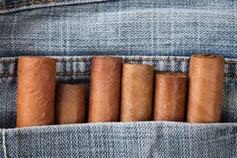 Cigar in the jeans pocket on back side Stock Photos