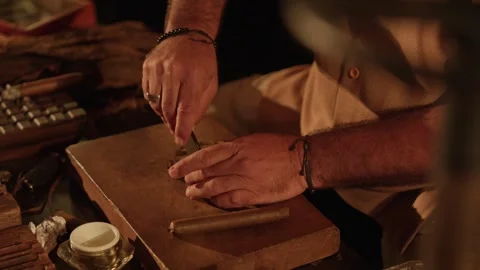 Cigar Maker Crafts a Hand Rolled Cuban Cigar in a Lounge Cutting Tobacco Leaves Stock Footage 288038852