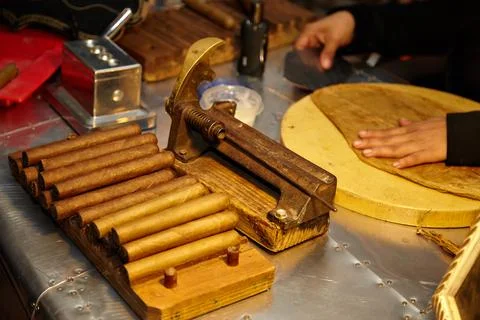 Cigar making with artisans in a traditional workshop, focusing on quality and Stock Photos