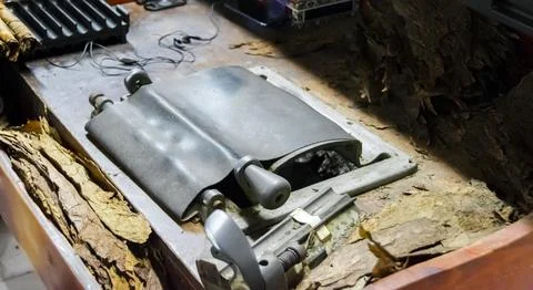 A cigar rolling machine Inside a cigar factory. Traditional manufacture of .. Stock Photos