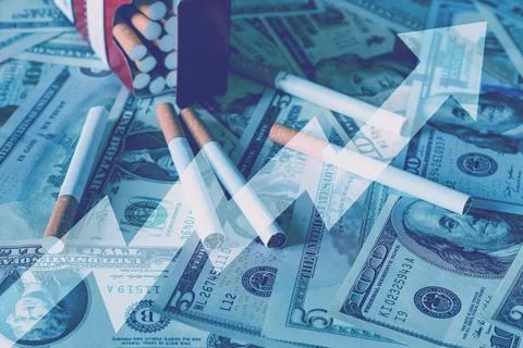 Cigaretes on a dollars background. Stock Photos